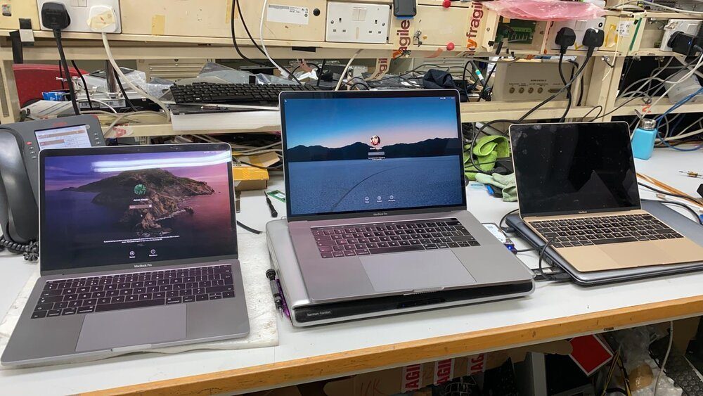 Three MacBooks running on the workshop bench